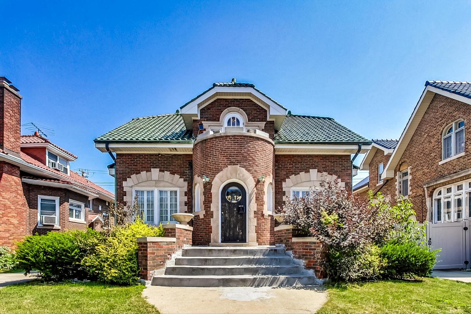 a front view of a house with a garden