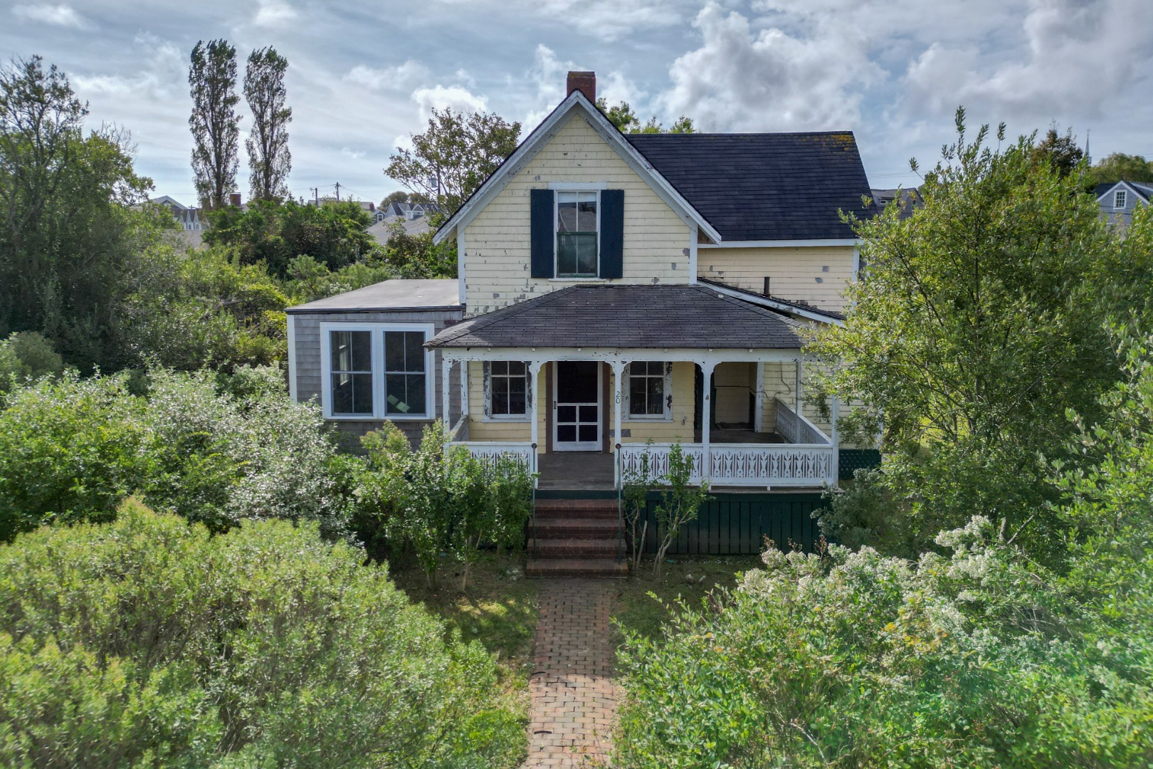 a front view of a house with a garden