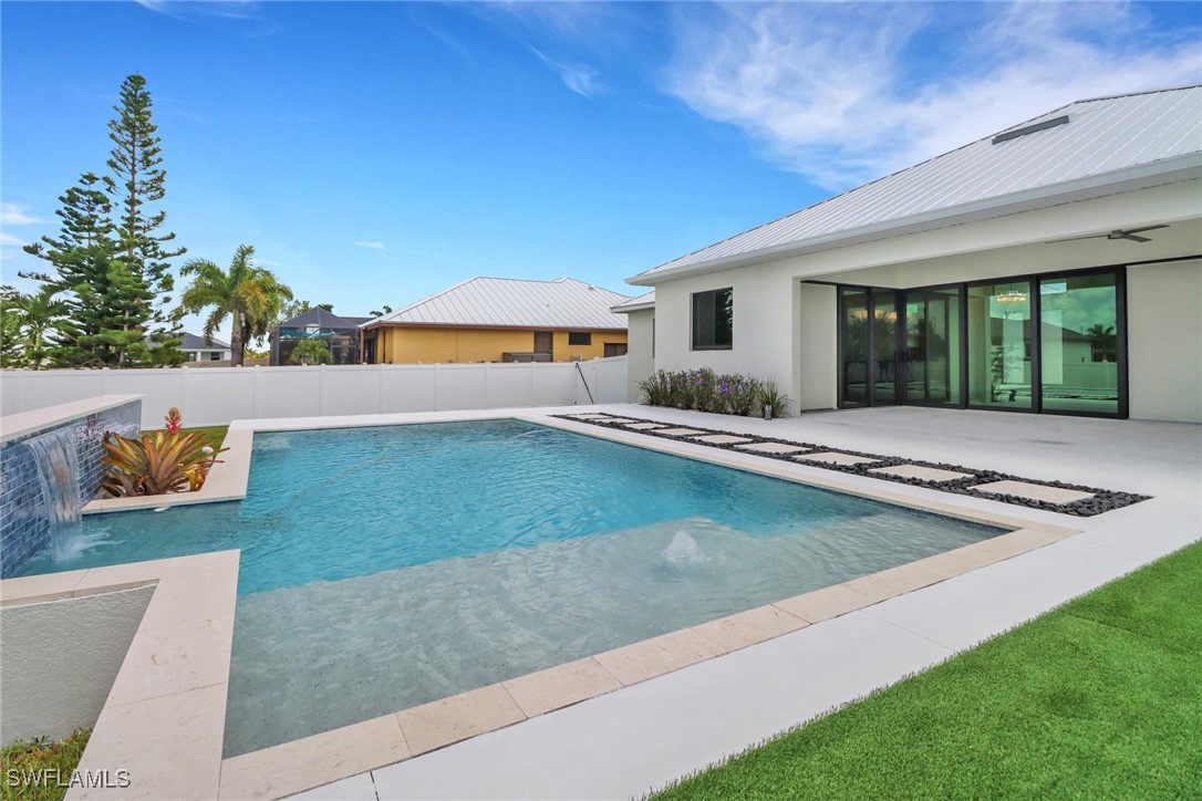 a view of a house with swimming pool and sitting area