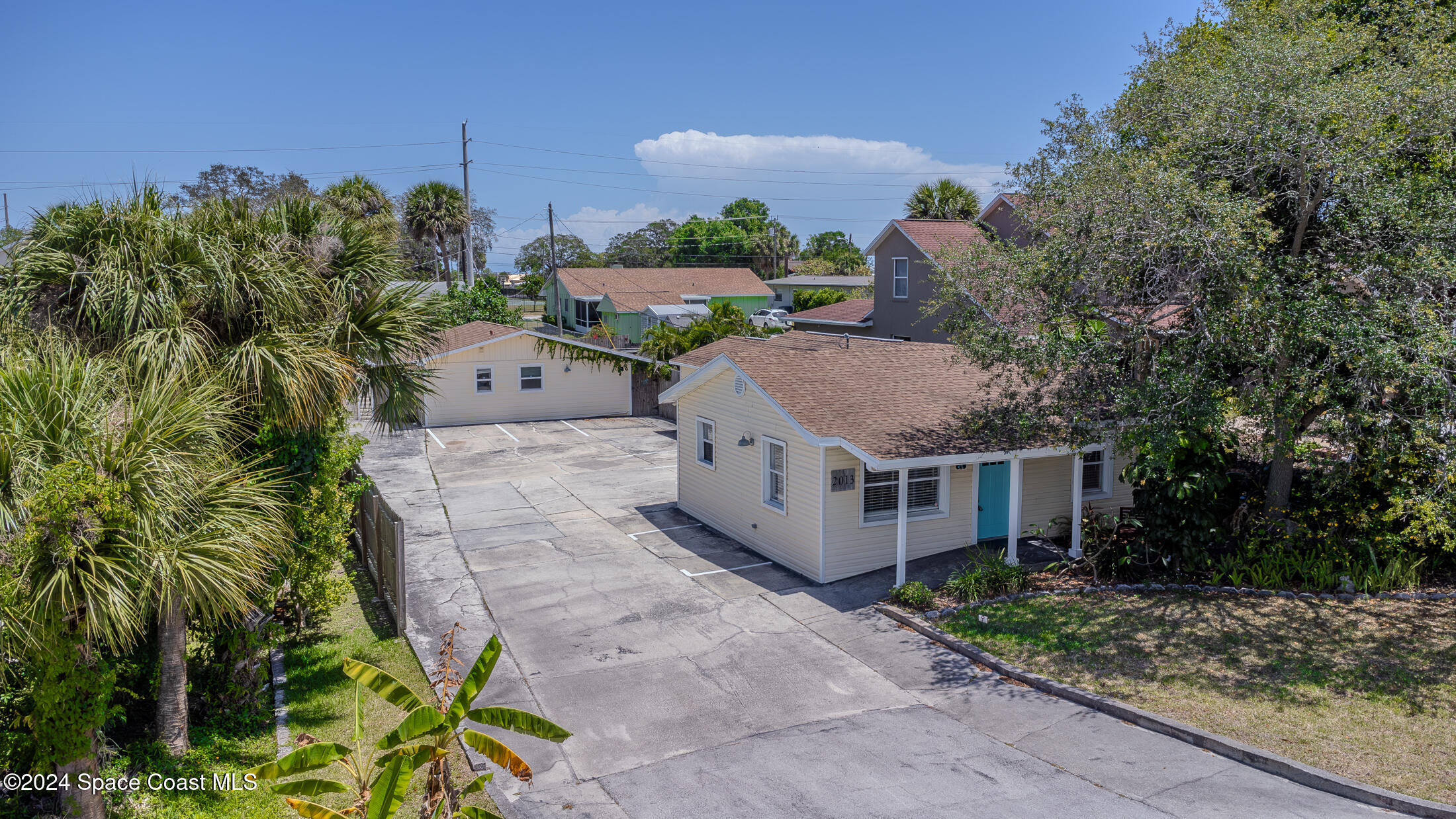 a aerial view of a house with a yard and plants