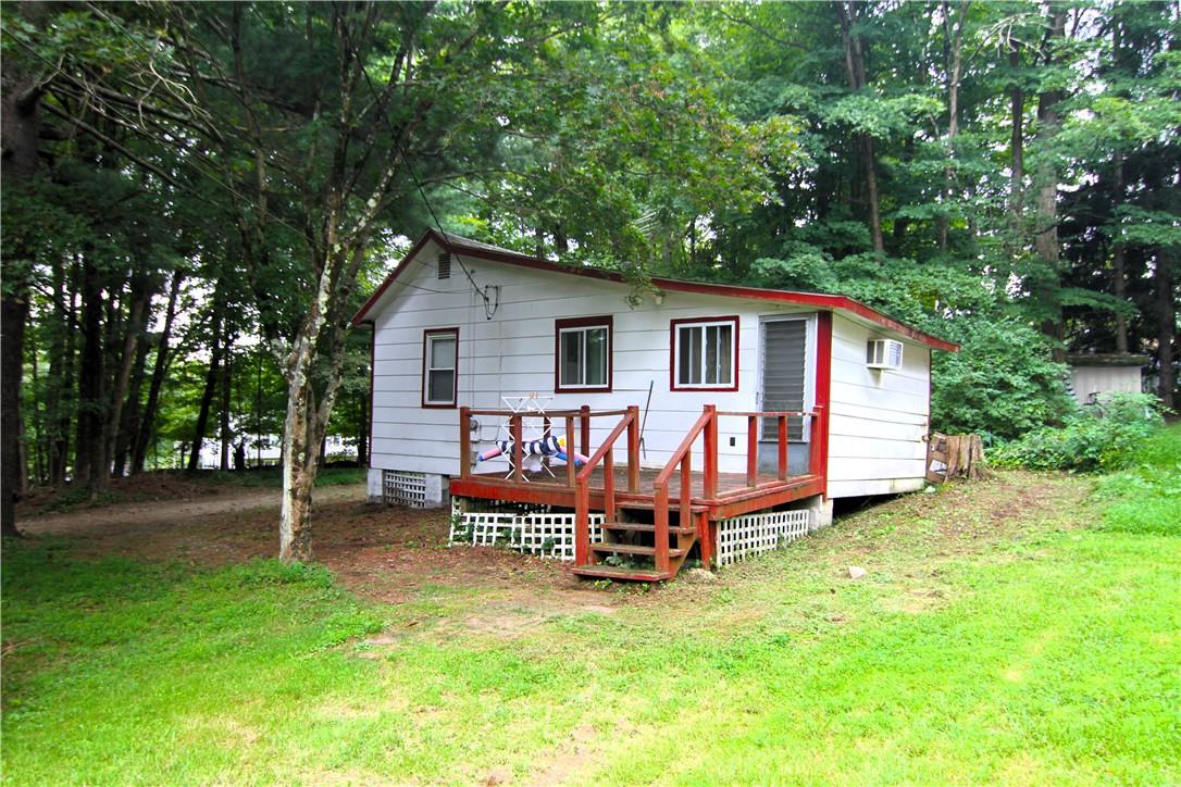 a view of a house with a yard porch and sitting area