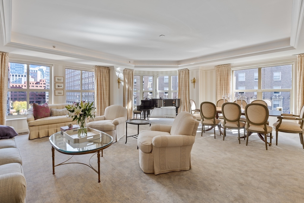 a living room with furniture a table and a large window