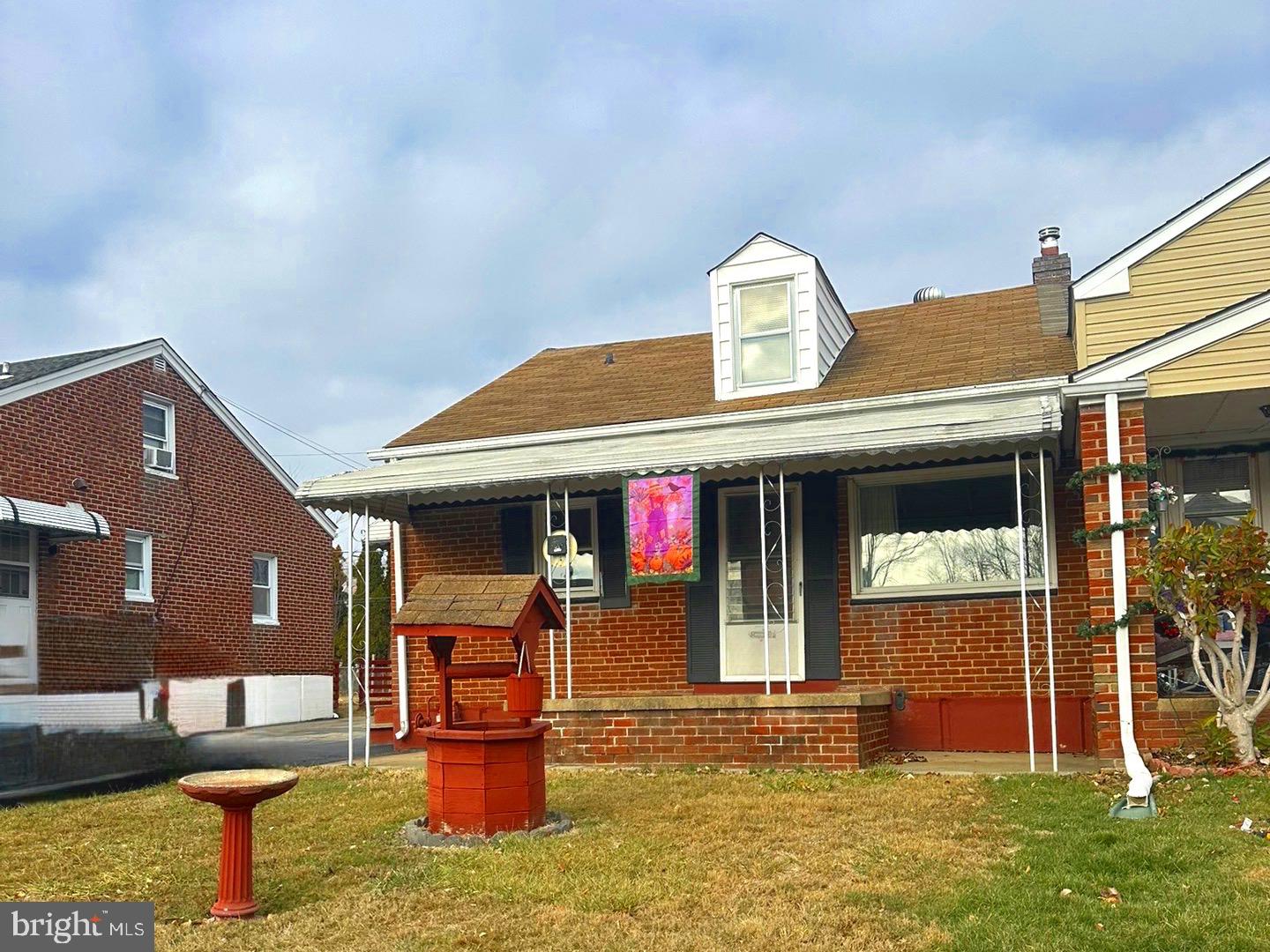 a front view of a house with outdoor seating