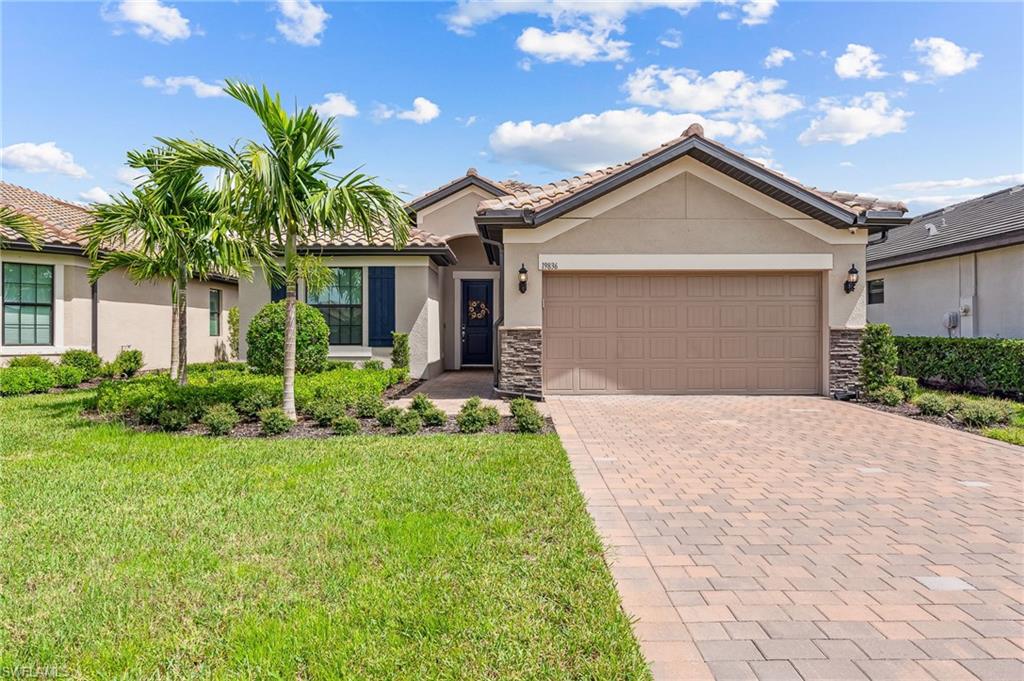 a front view of a house with a yard and garage