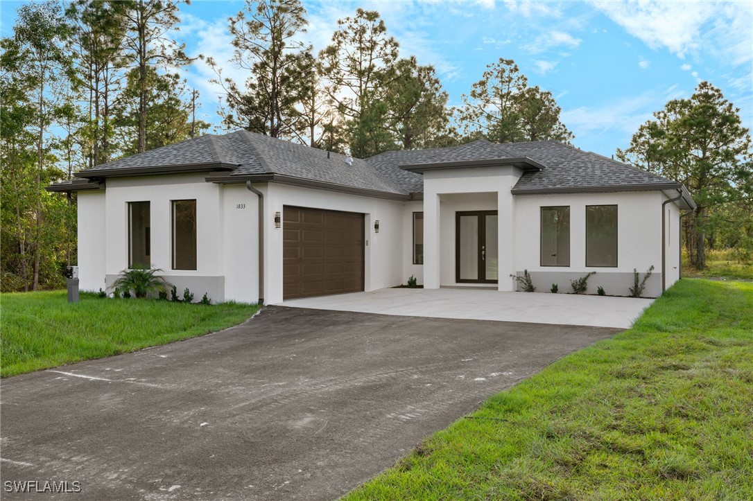 a front view of a house with a yard and garage