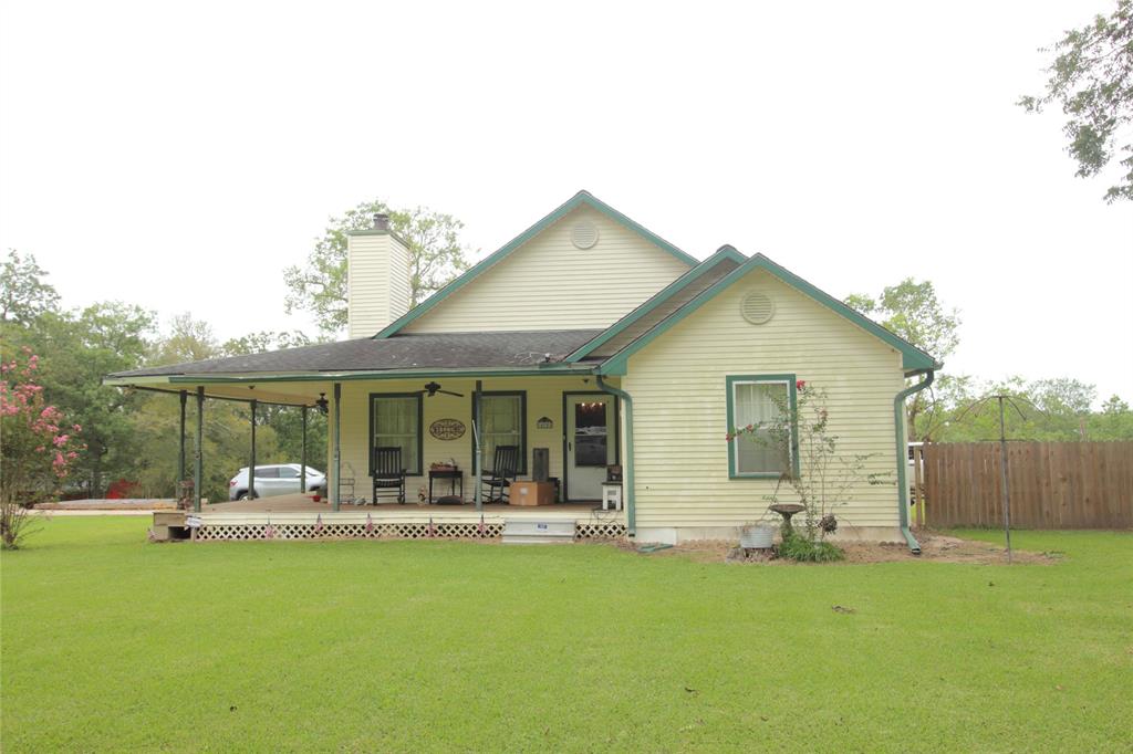 a front view of house with yard outdoor seating and barbeque oven