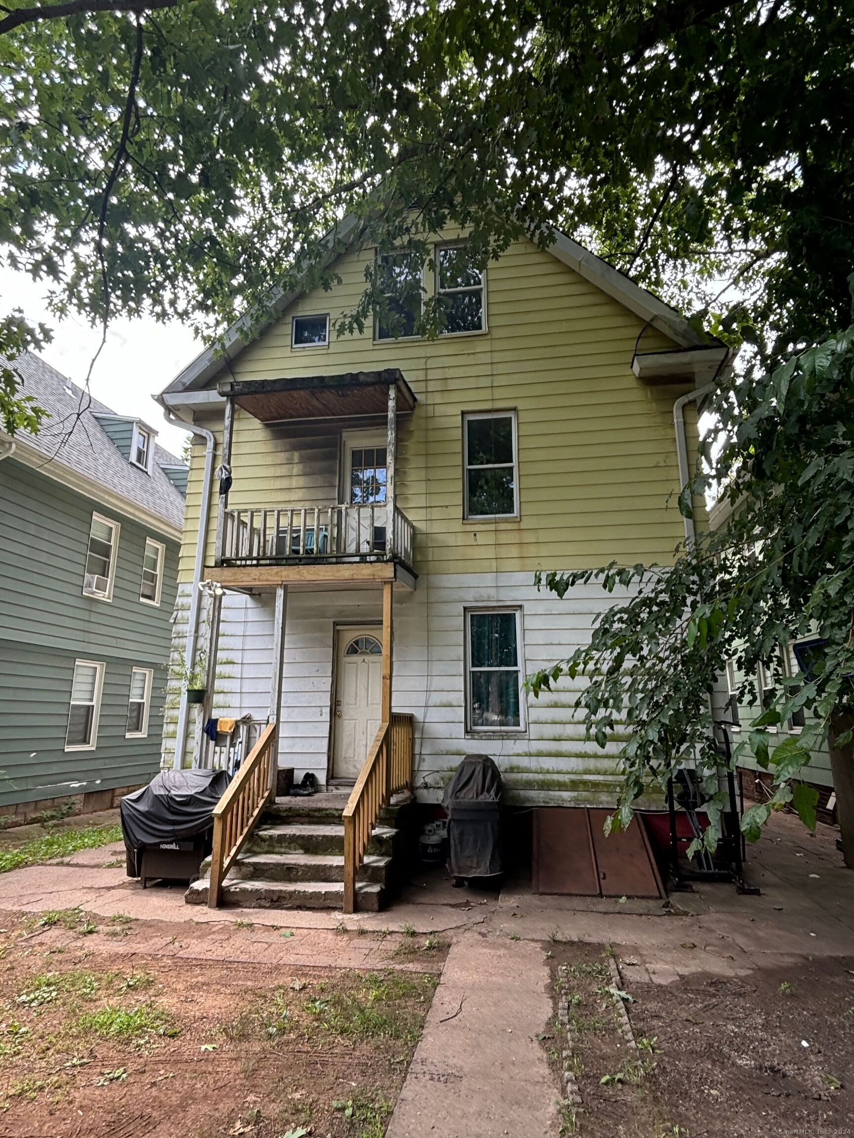 a view of a house with backyard space and sitting area