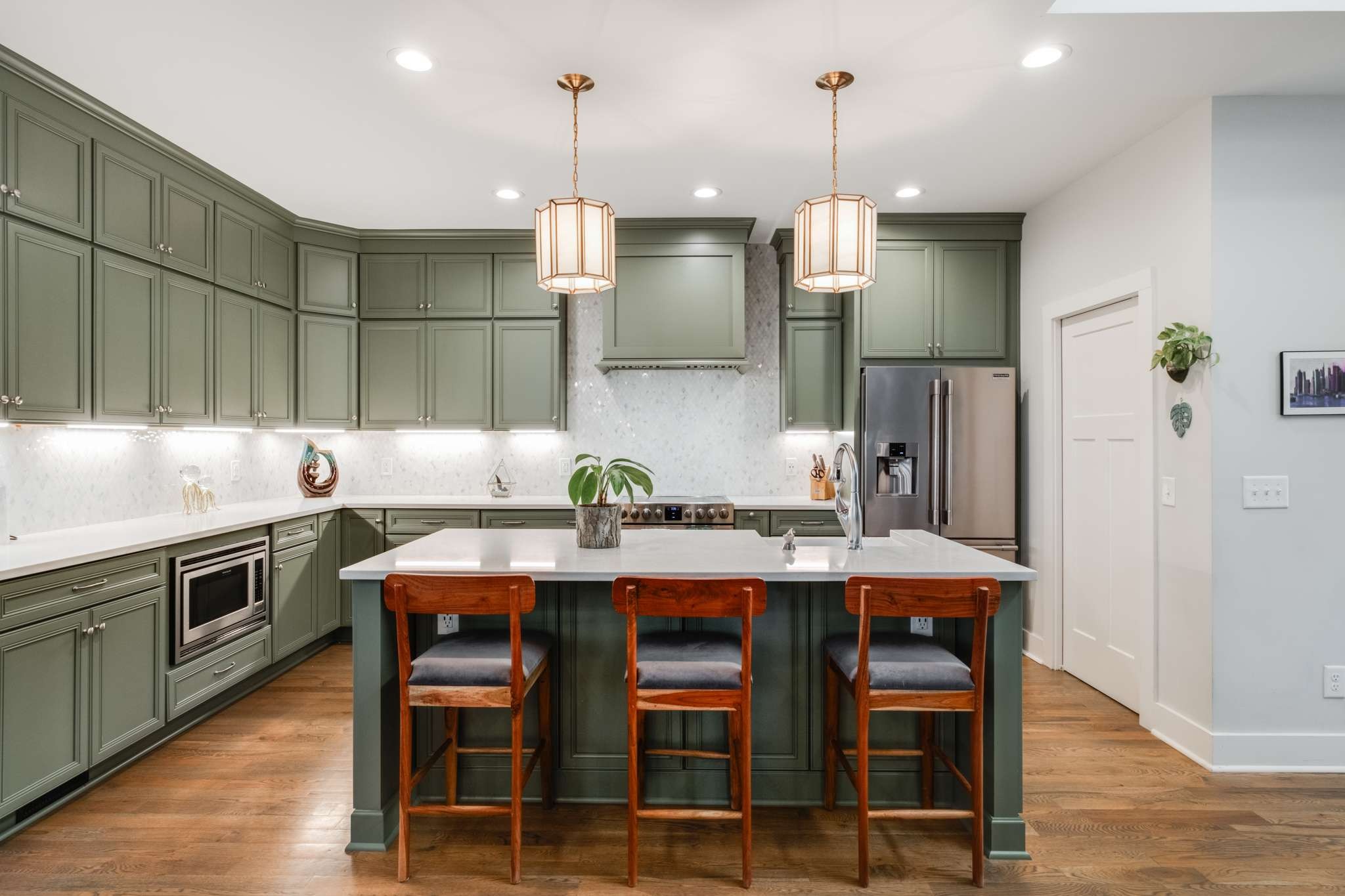 a kitchen with granite countertop a table chairs stove and cabinets