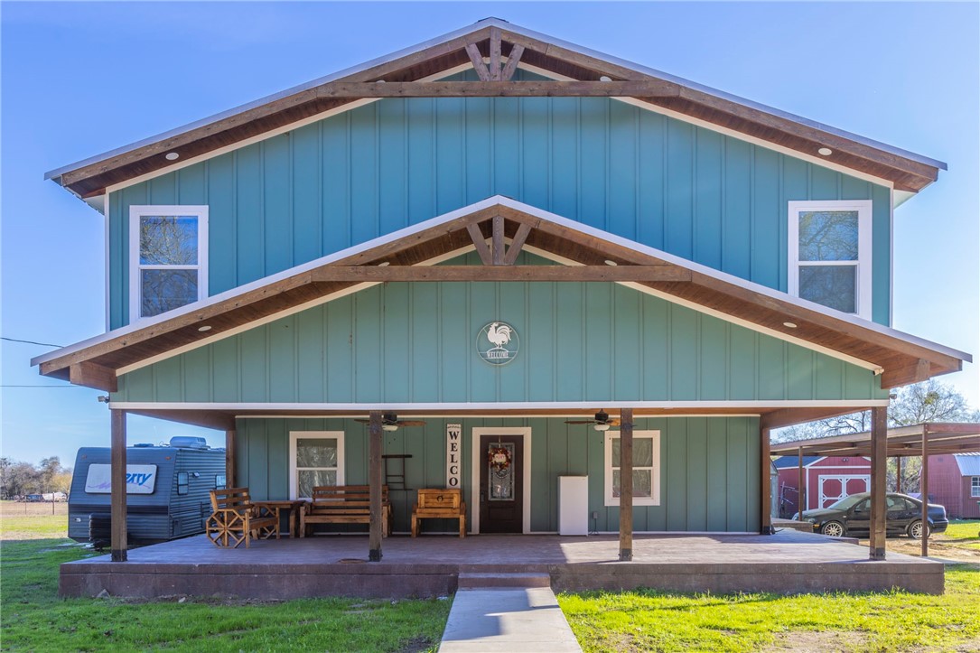 a front view of house with yard and outdoor seating