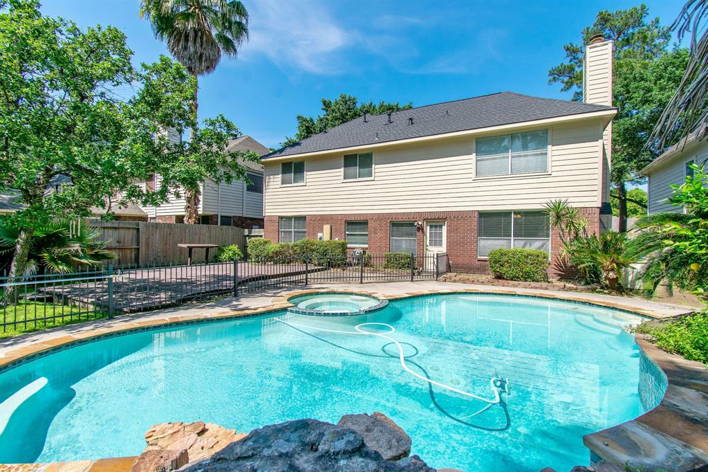 a view of a house with swimming pool and sitting area