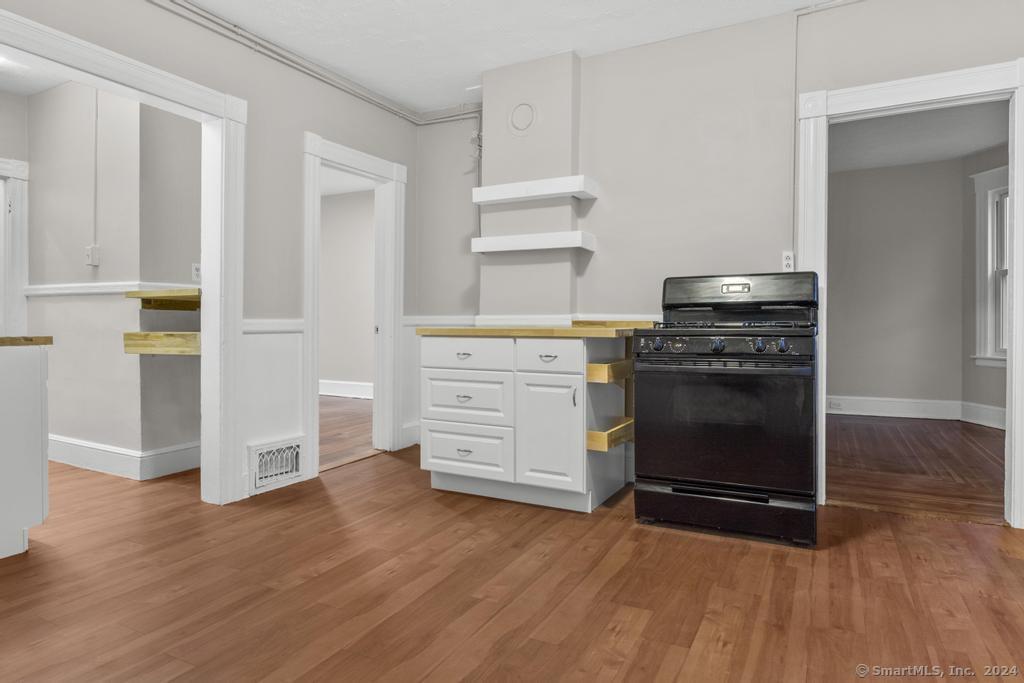 a kitchen with wooden floors and appliances