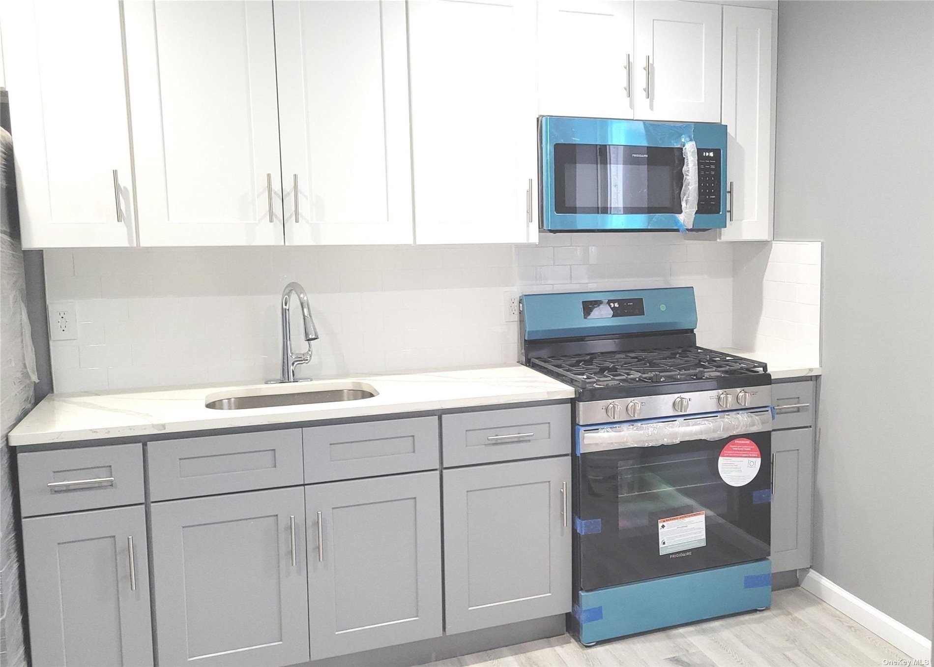 a kitchen with stainless steel appliances granite countertop a sink and a stove