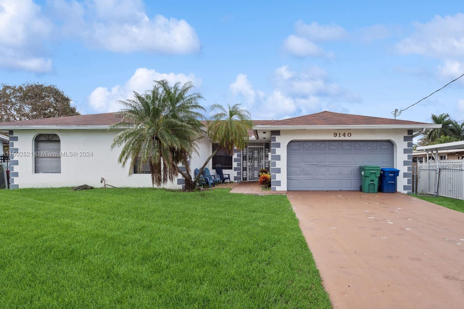 a view of a house with a yard and a patio