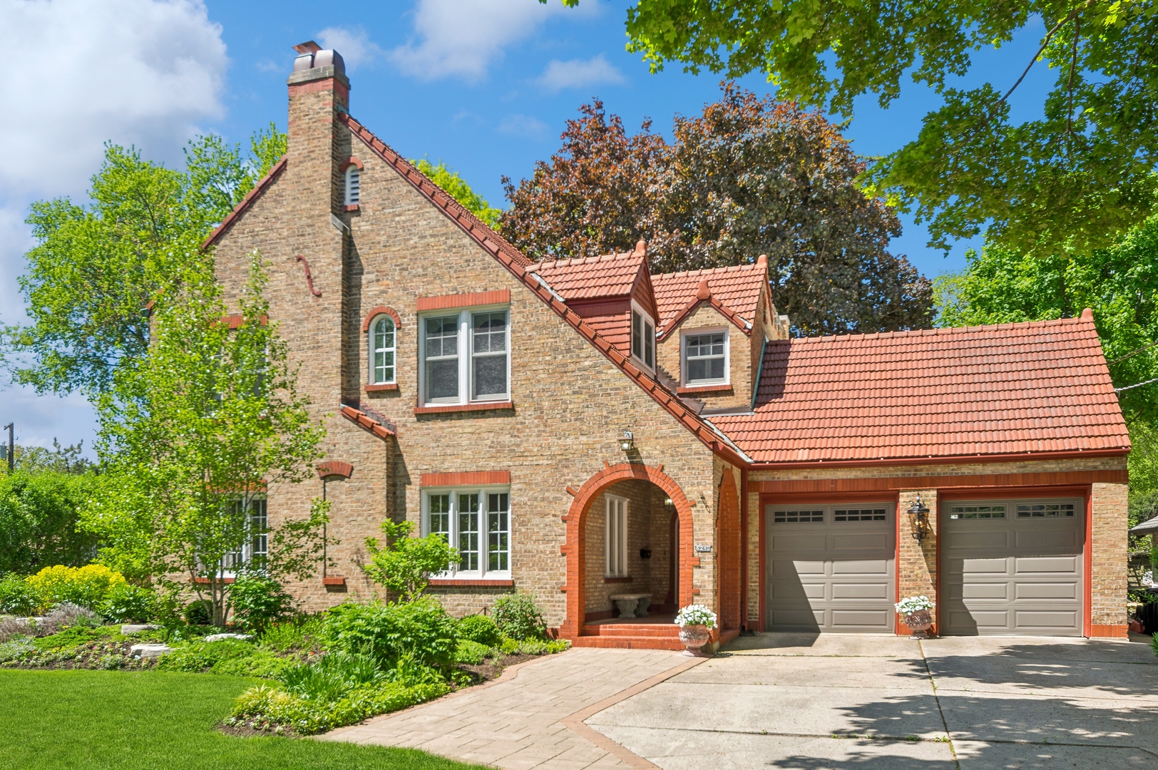 a front view of a house with garden