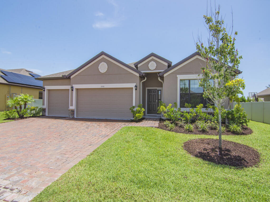 a front view of a house with a yard and garage