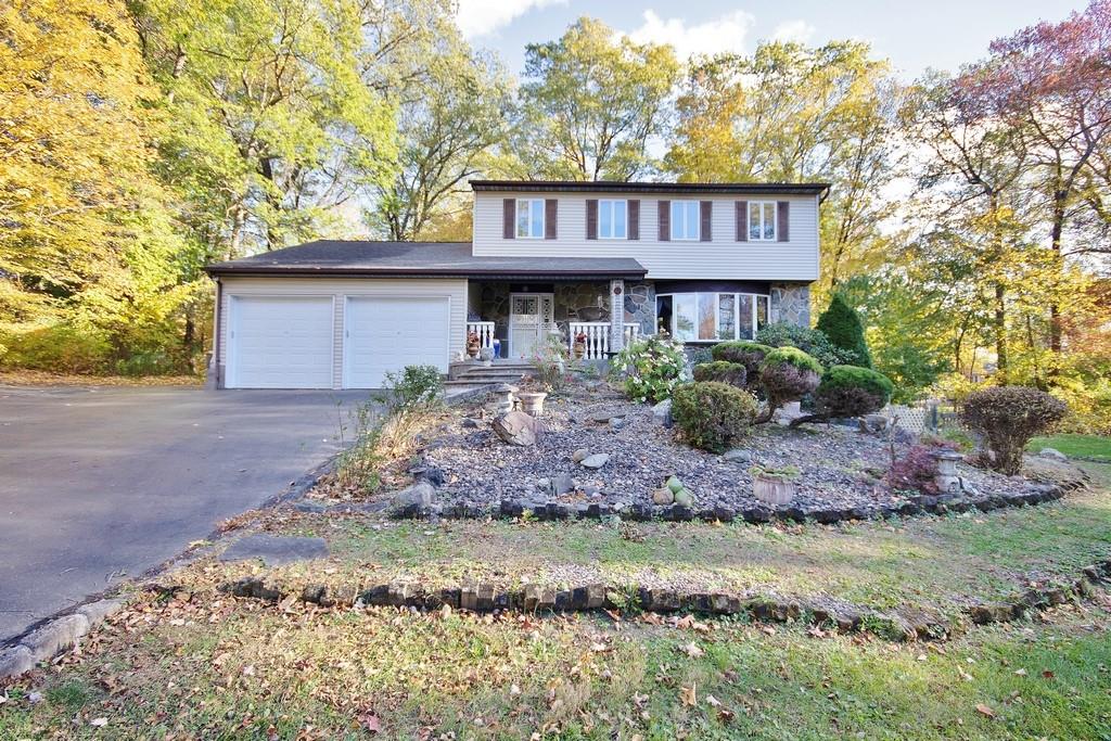 View of front of property featuring a garage and a porch