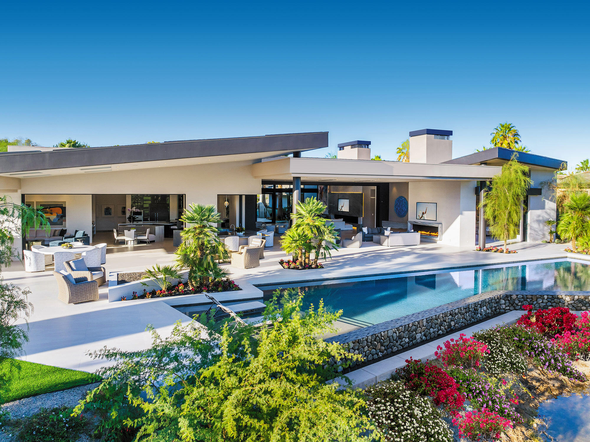 a view of house with a swimming pool and outdoor seating