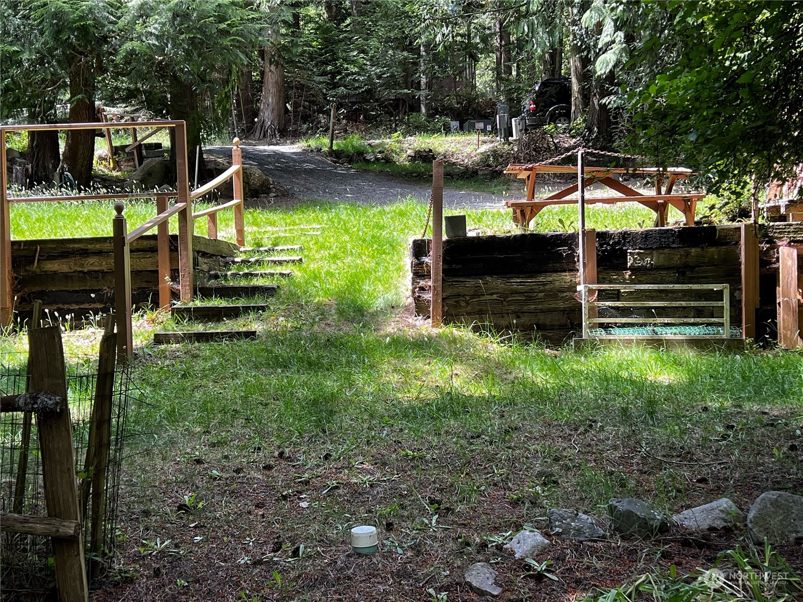 a view of a wooden deck and backyard