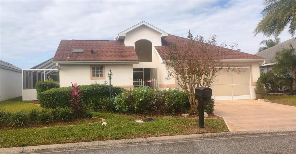 a front view of a house with garden