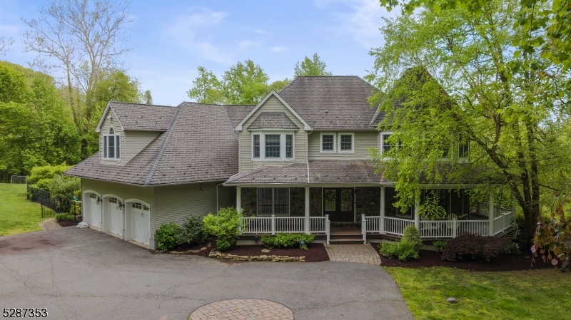 a front view of a house with a garden and plants