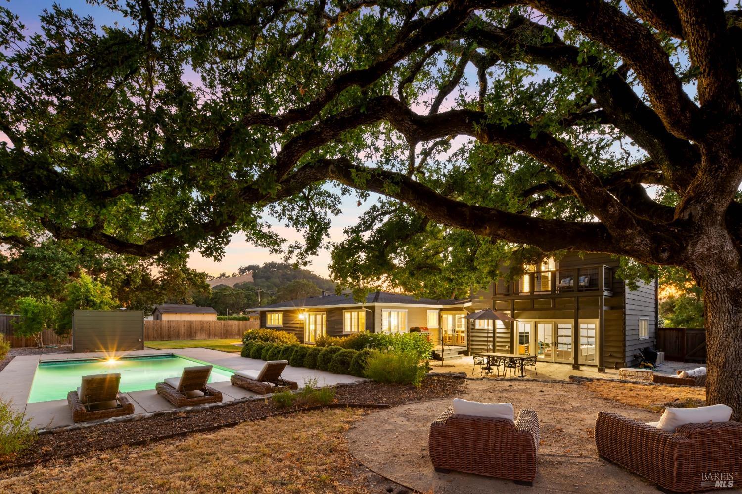 a view of a house with backyard water and sitting area