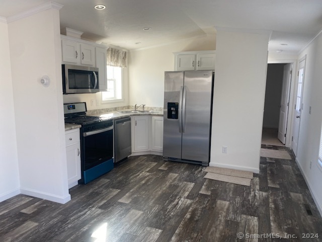 a kitchen with stainless steel appliances granite countertop a refrigerator sink and microwave