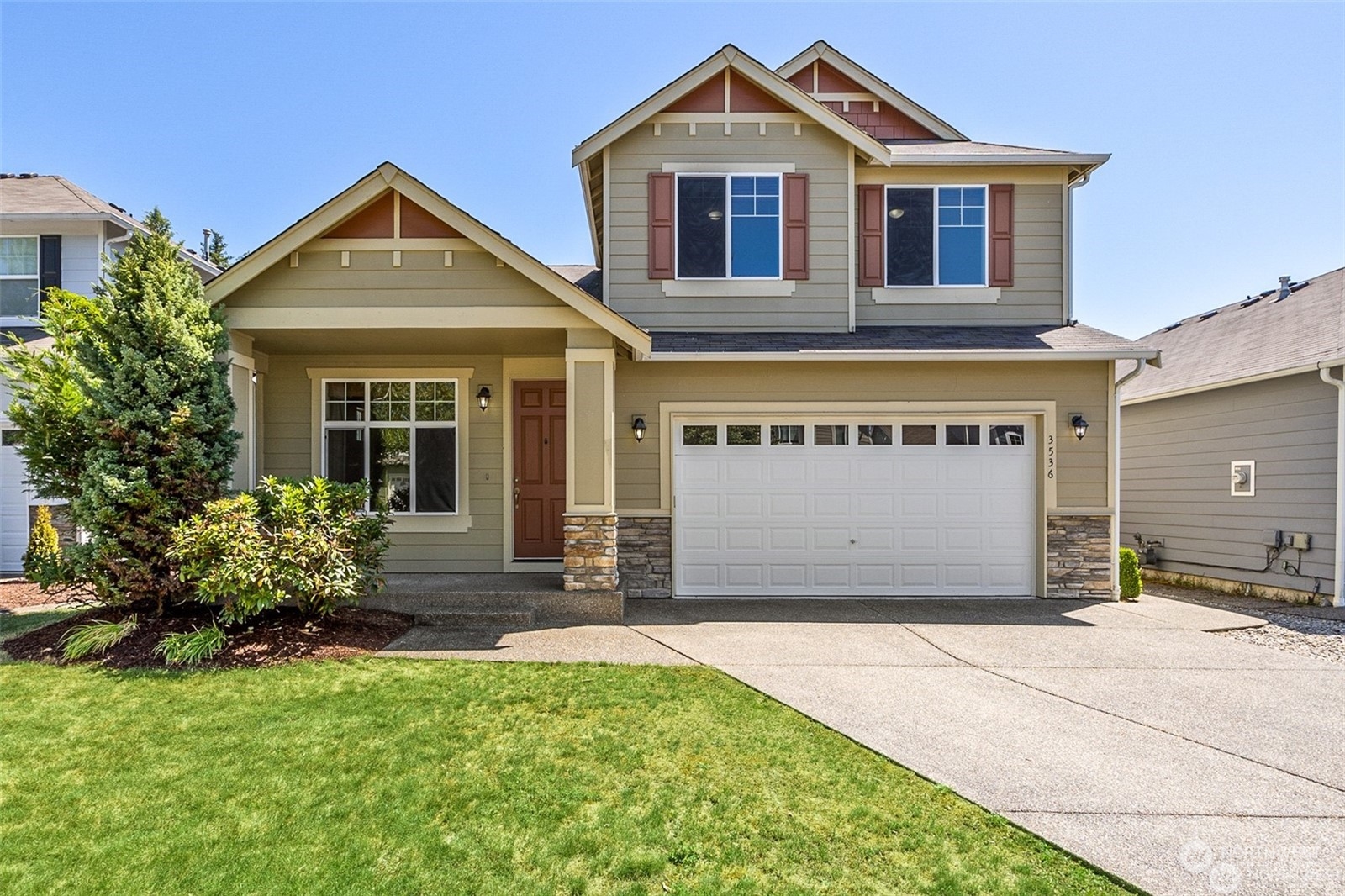 a front view of a house with a yard and garage