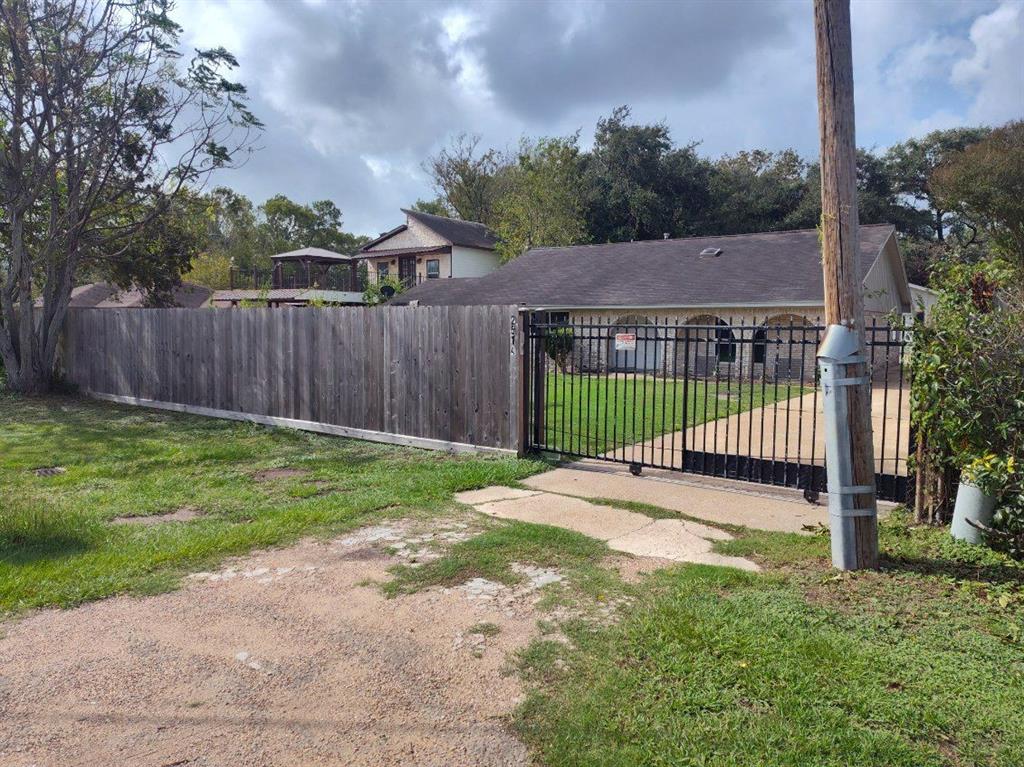 a view of a backyard with a small yard and wooden fence