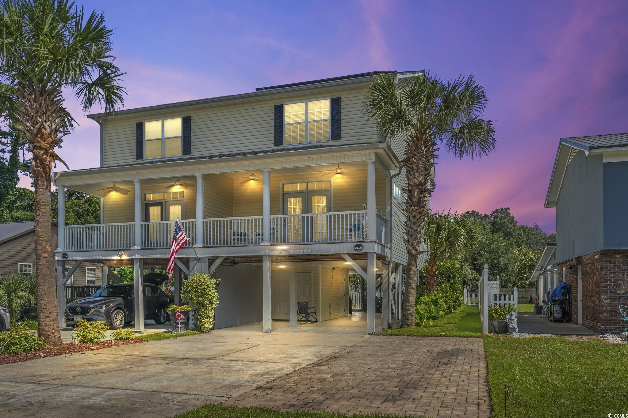 View of front of property with a carport and cover