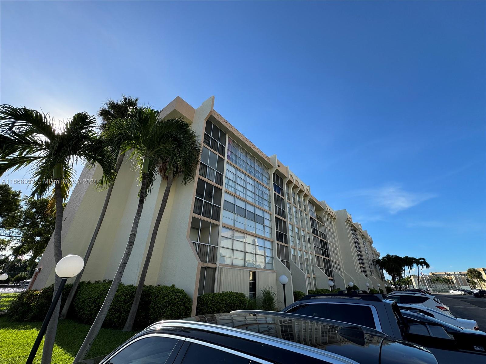 a view of a tall building next to a yard