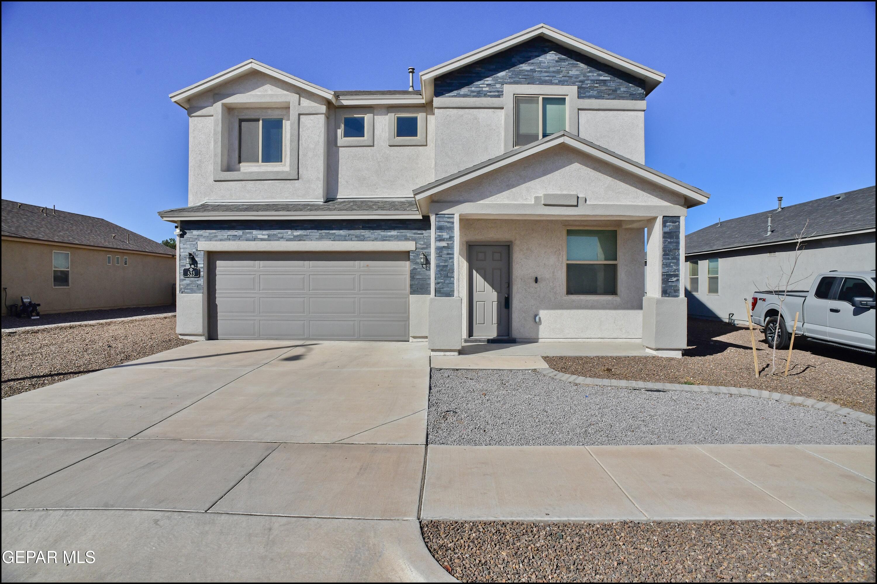 a front view of a house with garage