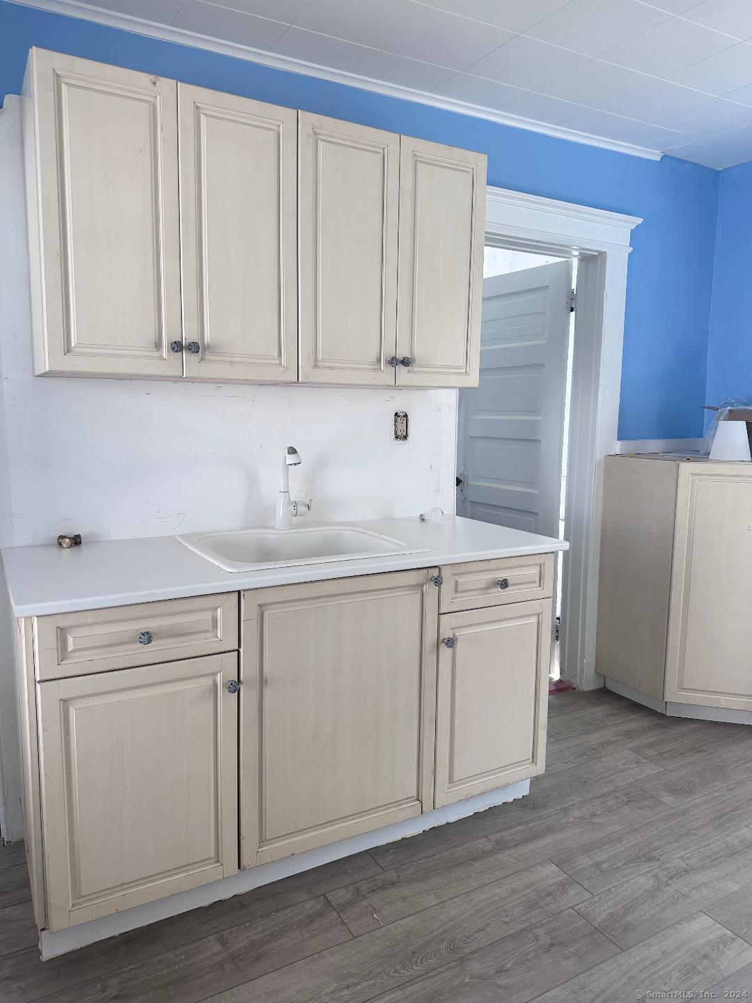 a kitchen with white cabinets and white appliances