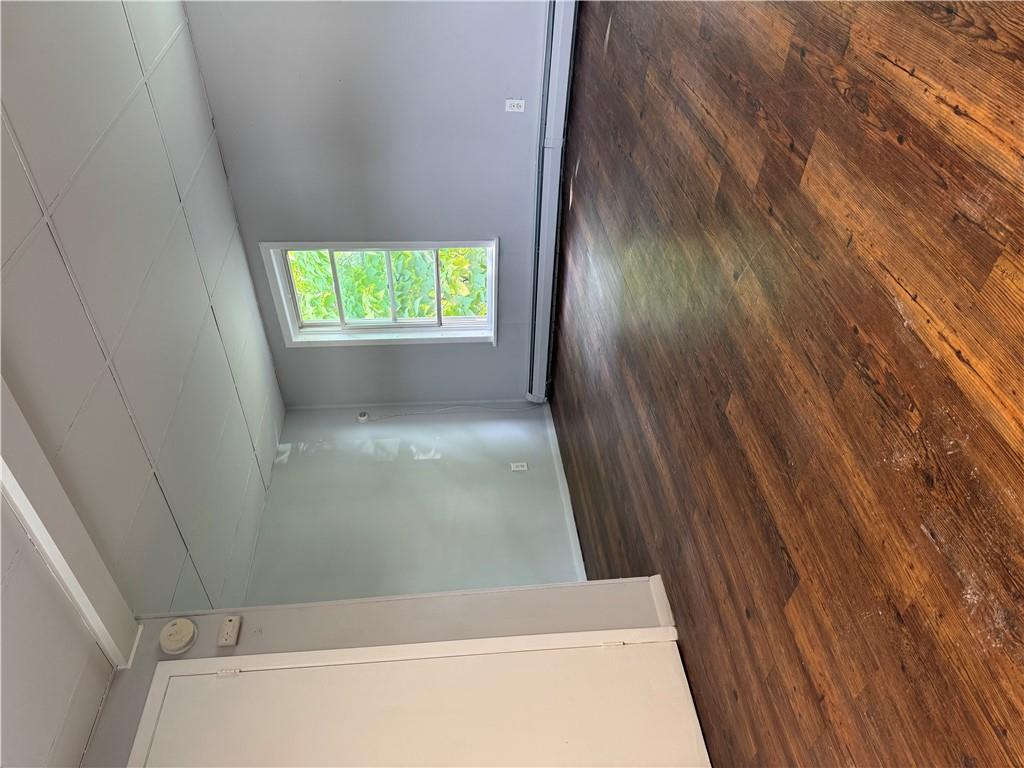 a view of room with window and wooden floor