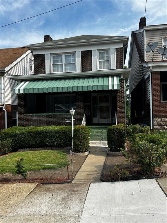 a front view of a house with a yard