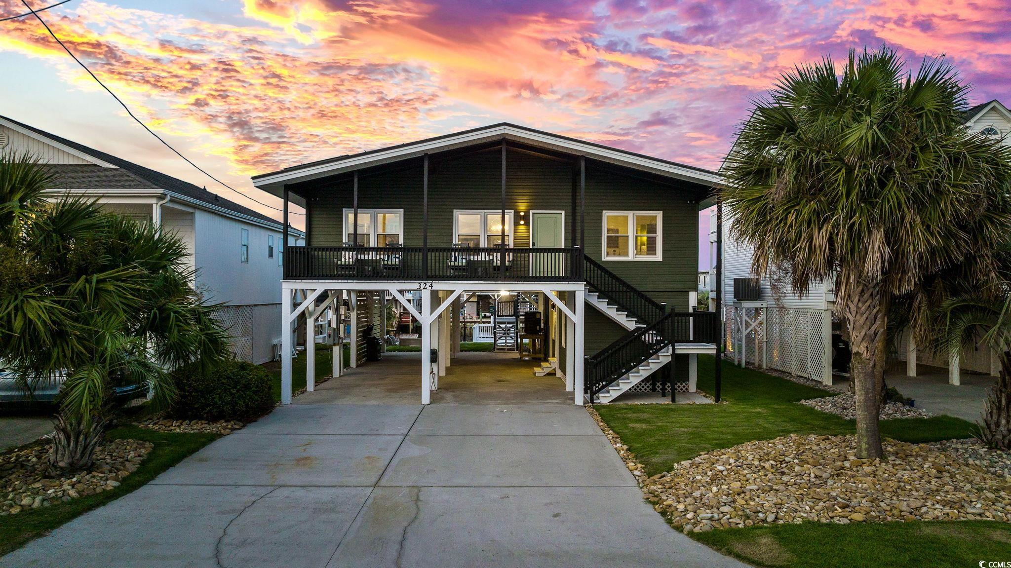 Beach home featuring a carport and covered porch