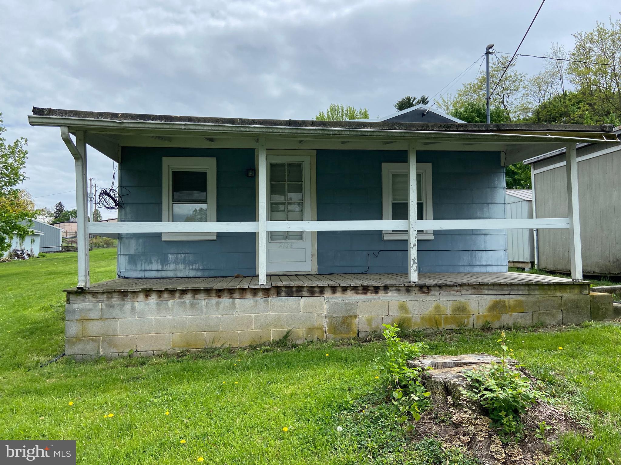 a view of a house with a yard and sitting area