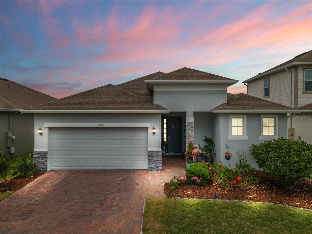 a front view of a house with a yard and outdoor seating