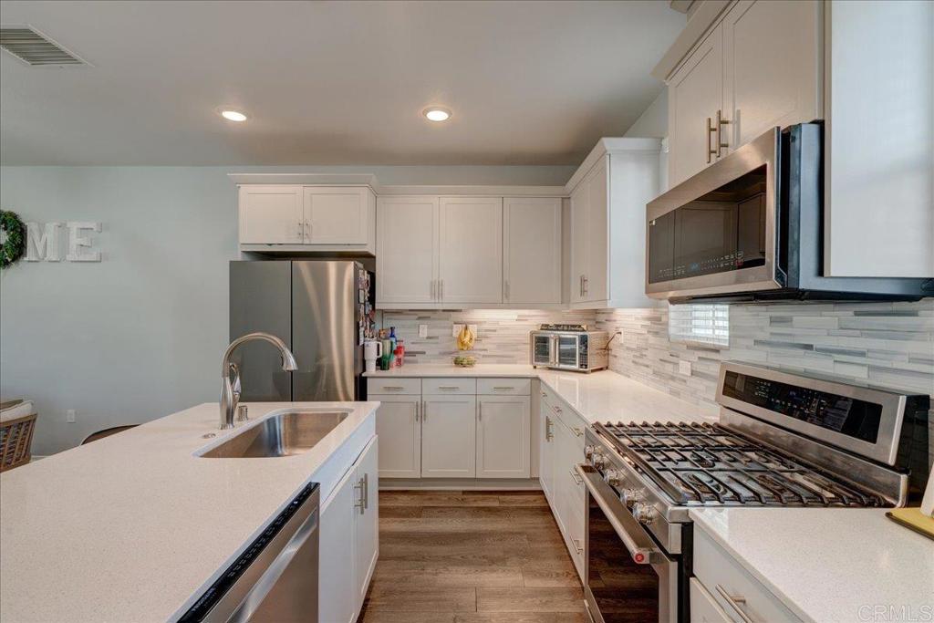 a kitchen with a sink a stove and refrigerator