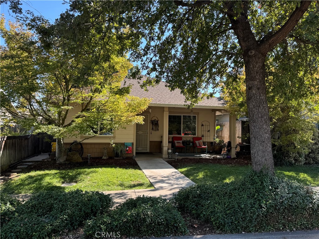 a front view of a house with a yard and trees