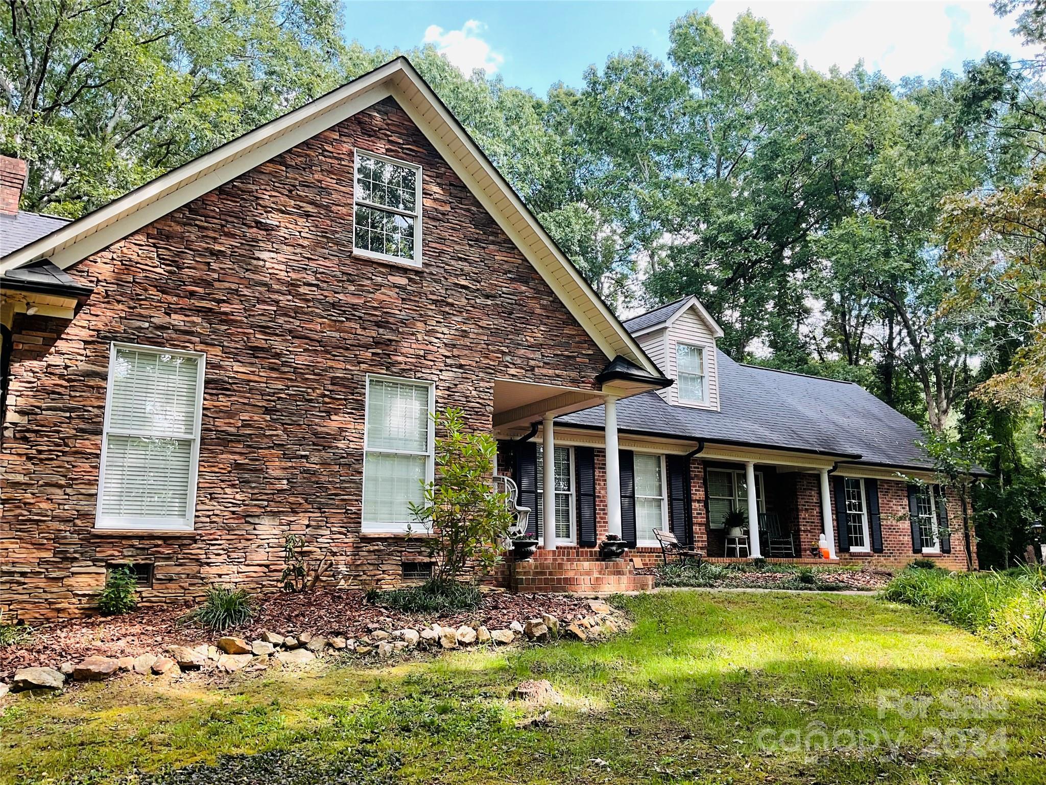 a view of a house with swimming pool and porch