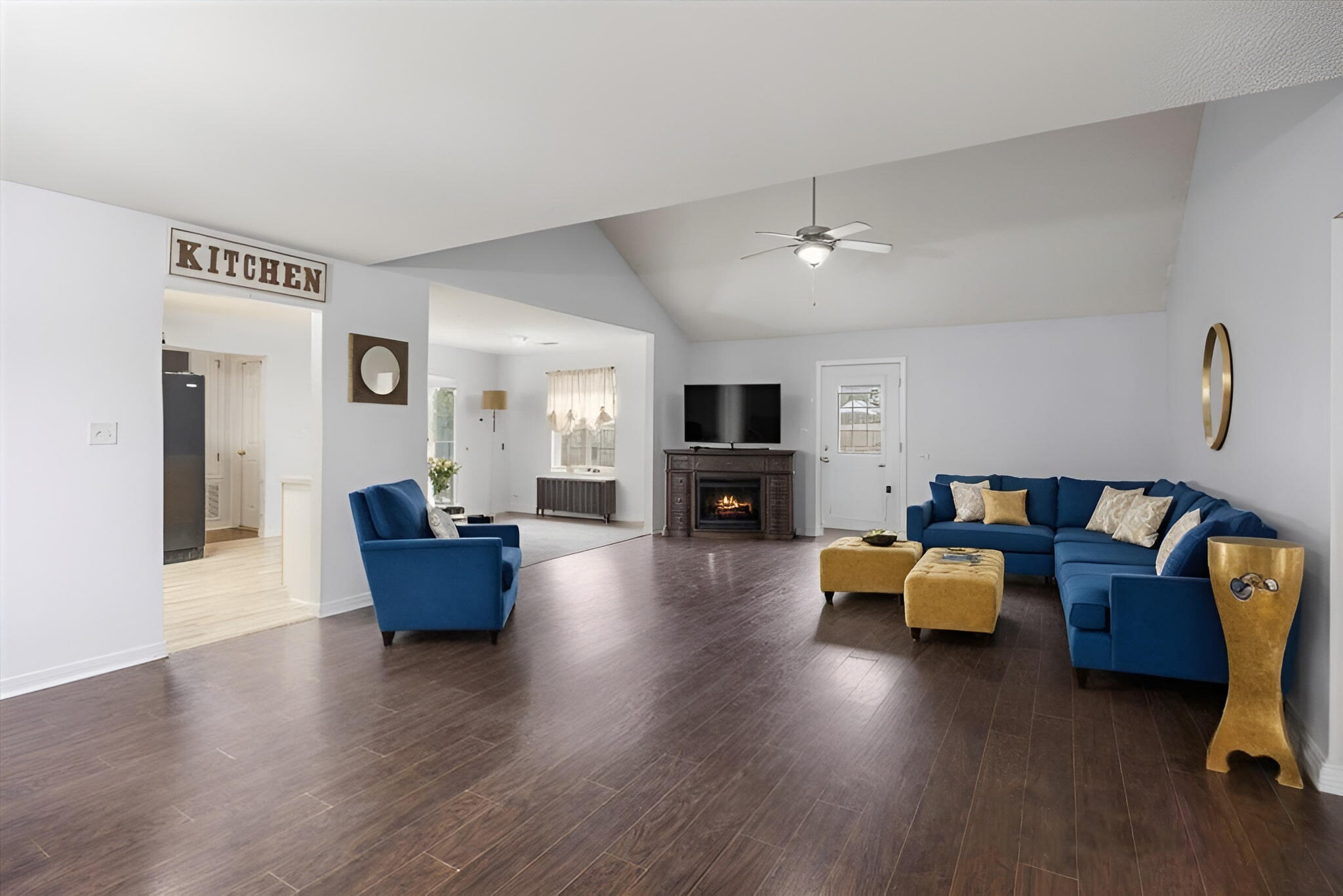 a living room with fireplace furniture and a wooden floor