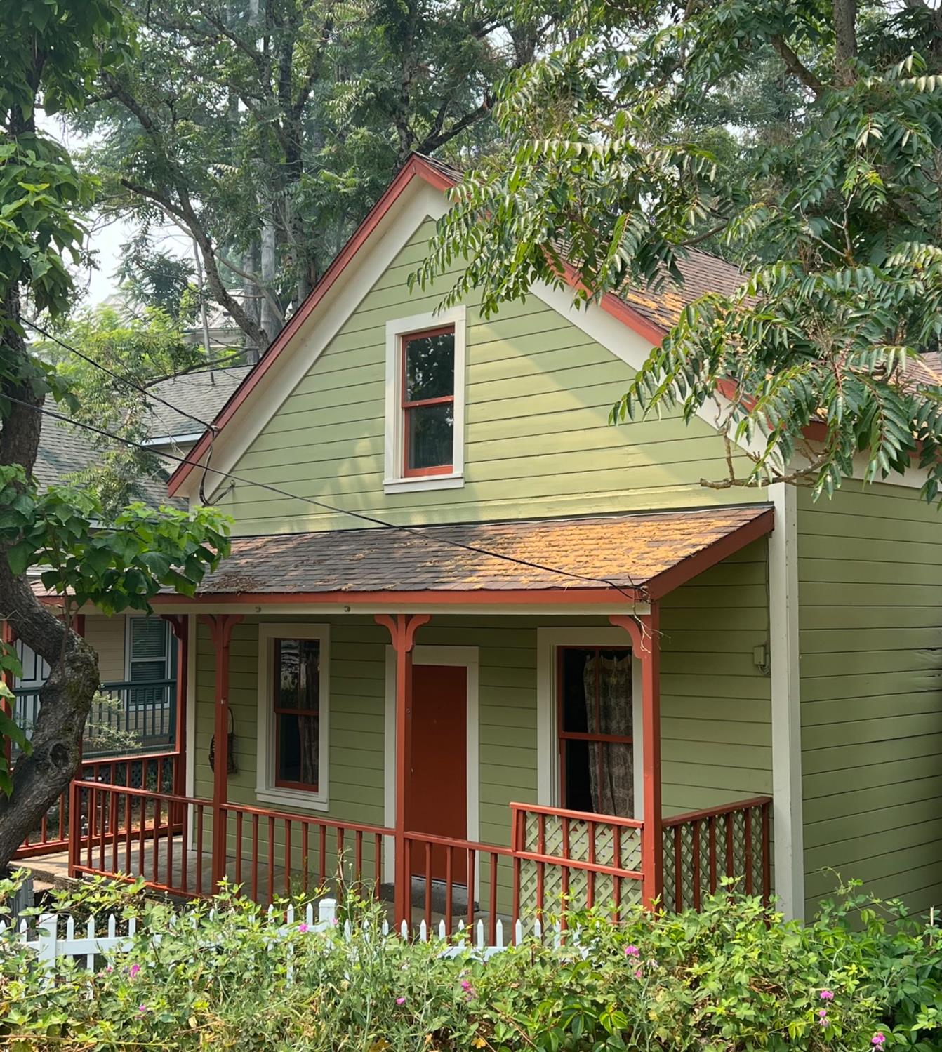 a front view of a house with a garden