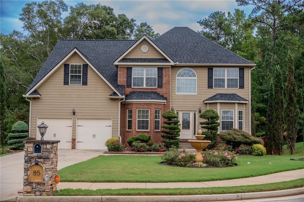 a front view of a house with a yard and garage