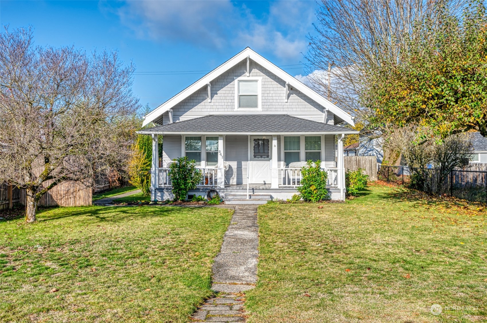 a front view of a house with yard and green space