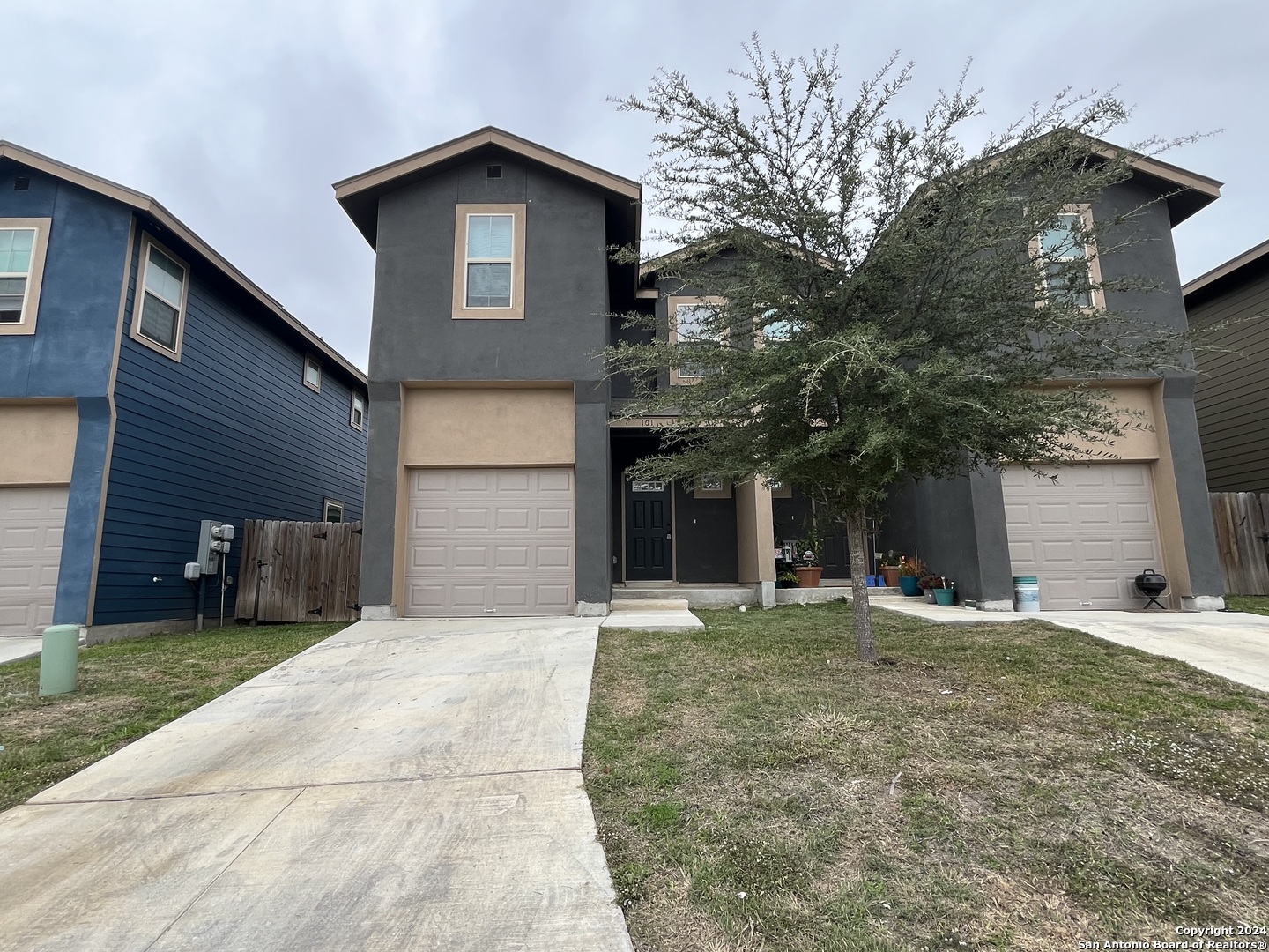 a front view of a house with a yard and garage