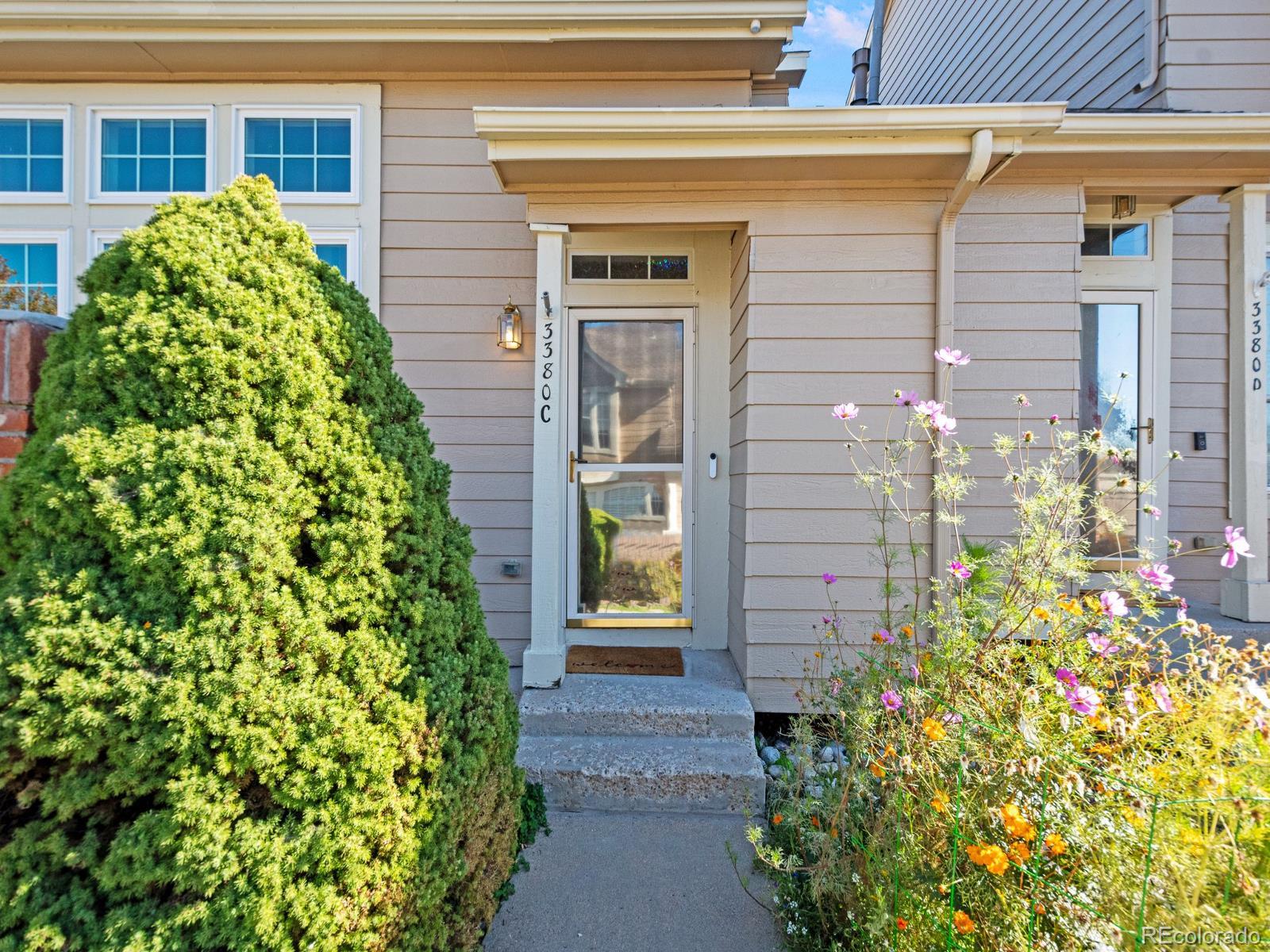 a front view of a house with a garden