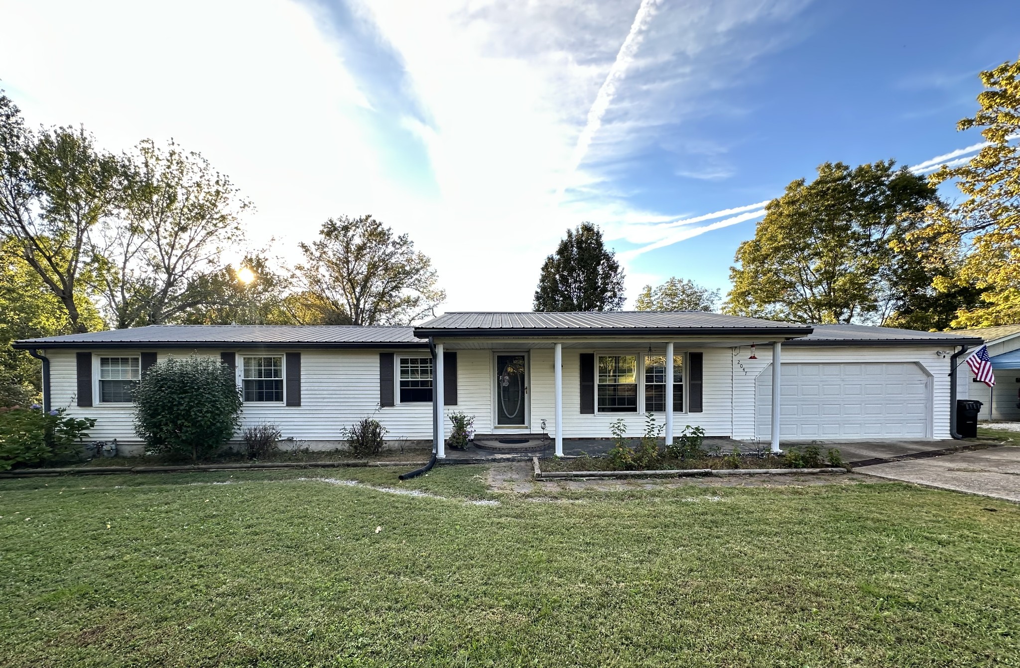 a front view of house with yard and green space