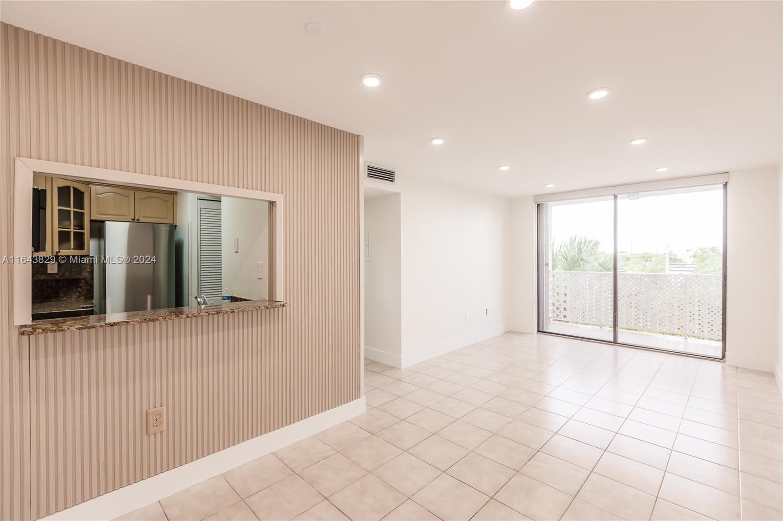 a view of an empty room and a window