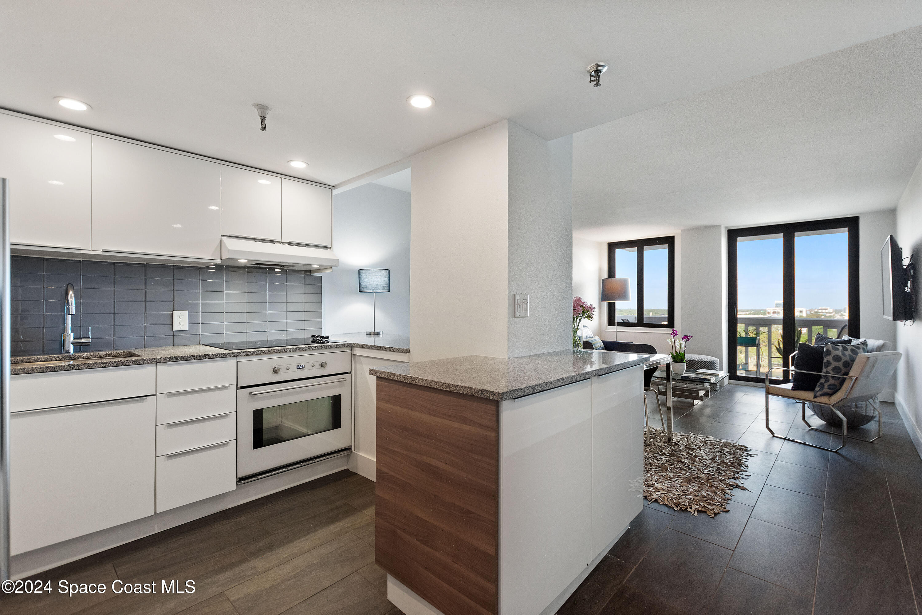 a kitchen with stainless steel appliances granite countertop a stove oven and a refrigerator