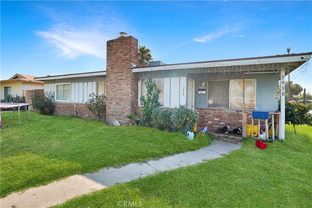 a front view of house with yard and outdoor seating